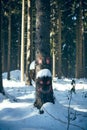 View at the winter forest with a smiley face drawn on a tree trunk