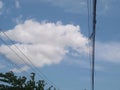 View of wires crossing the blue sky with white clouds Royalty Free Stock Photo