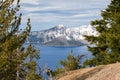 View of Wizard Island and Crater Lake through trees on the rim Royalty Free Stock Photo