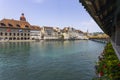 View of the wodden covered Kapellbrucke Bridge on the Reuss river and buildings in city