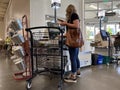 Lynnwood, WA USA - circa March 2022: View of a woman checking out in the self-checkout area of a Town and Country Market