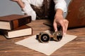 View of woman holding steampunk goggles at workplace