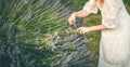 View of woman making wreath with beautiful flowers.