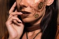 View of woman with steampunk makeup on brown