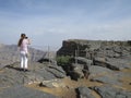 View of a woman taking picture of the Arabian Grand Canyon, Sultanat of Oman. Royalty Free Stock Photo