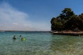 View of the woman and two children swimming in crystal clear water in Rovinj, Croatia Royalty Free Stock Photo