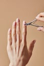 View of woman using cuticle nipper