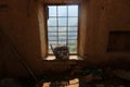 View with the wooden basket on the dark window in old abandoned house Royalty Free Stock Photo