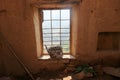 View with the wooden basket on the dark window in old abandoned house Royalty Free Stock Photo