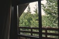 View from wooden cabin window on trees, woods and mountains. Space for text. Travel and vacations. Relaxing in log in forest Royalty Free Stock Photo