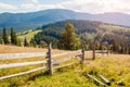 View of wooden fence in Carpathian mountains. Summer ukrainian landscape. Wild nature with forest on hills Royalty Free Stock Photo