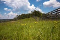 View of the wooden fence, meadow and amazing blue cloudy sky Royalty Free Stock Photo