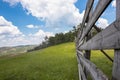 View of the wooden fence, meadow and amazing blue sky Royalty Free Stock Photo