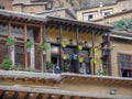 A view of a wooden house in the historic city of Masouleh, Geranium flowers arranged in Porch of house, Iran, Gilan