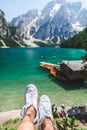 view of wooden house on water with pier and boats lake in dolomites mountains Royalty Free Stock Photo