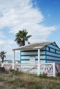 Wooden hut and palm tree on the beach in Gruissan in France Royalty Free Stock Photo