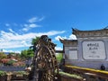 View of a wooden mill and the buildings in Yunnan Lijiang Dayan old town under the blue sky