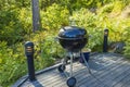 View of wooden patio of typical  wooden swedish house with with barbecue grill sitting area.  Sweden. Royalty Free Stock Photo