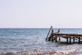 View of a wooden pier and seascape with running waves