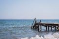 View of a wooden pier and seascape with running waves Royalty Free Stock Photo