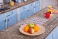 View on the wooden table at kitchen with fruit and teaspot on it.