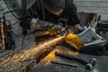 View of worker grinding a piece of metal, Poncin Metal industry, France