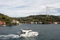 View of yacht passing on Bosphorus by Kanlica neighborhood on Asian side of Istanbul.