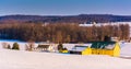 View of a yellow barn and farm during the winter in rural York C