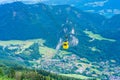 View of mountains and yellow Seilbahn cable car gondola from Zwolferhorn mountain