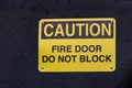 View of yellow sign Caution Fire Door Do Not Block