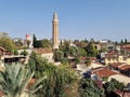 View of the Yivliminare Mosque minaret and cityscape before a blue skyline Royalty Free Stock Photo