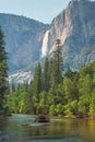 View of Yosemite Falls from the bridge above Merced River in Yosemite Valley National Park, California, USA.