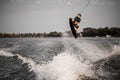 view of young athlete guy doing an extreme jump on wakeboard Royalty Free Stock Photo