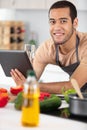 view young attractive man cooking in kitchen Royalty Free Stock Photo
