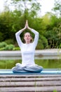 Young attractive woman practising yoga in a park Royalty Free Stock Photo