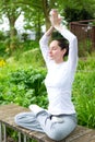 Young attractive woman practising yoga in a park Royalty Free Stock Photo