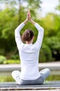 Young attractive woman practising yoga in a park Royalty Free Stock Photo