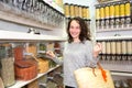 Young attractive woman shooping looses spices at the grocery Royalty Free Stock Photo