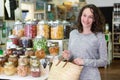 Young attractive woman shooping looses spices at the grocery Royalty Free Stock Photo