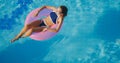 View of young brunette woman swimming on the inflatable pink ring Royalty Free Stock Photo