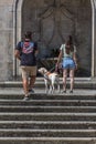 View of young couple climbing the stairs of Lamego Cathedral with labrador guide dog