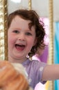 Young girl riding on fairground horse on carousel amusement ride at fairgrounds park outdoor Royalty Free Stock Photo