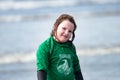 Young little girl on beach taking surfing lessons