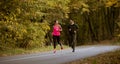 Young people jogging and exercising in autumn nature enviroment