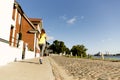 View of young woman running on sidewalk in morning. Health conscious concept Royalty Free Stock Photo