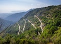 View of zigzag mountain road with hairpin bends in the Apuan Alps, Alpi Apuane, near the Vestito Pass. Above Massa