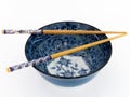 Blue asian porcelain bowl with chopsticks.