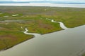 Rivers and inlets cut through the green and red tundra as they flow to the ocean in Alaska.