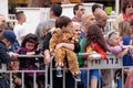 Viewers from behind dividing fence look at the ÃÂarnival parade