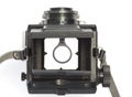 The viewfinder of an old, dual-lens reflex camera with a magnify